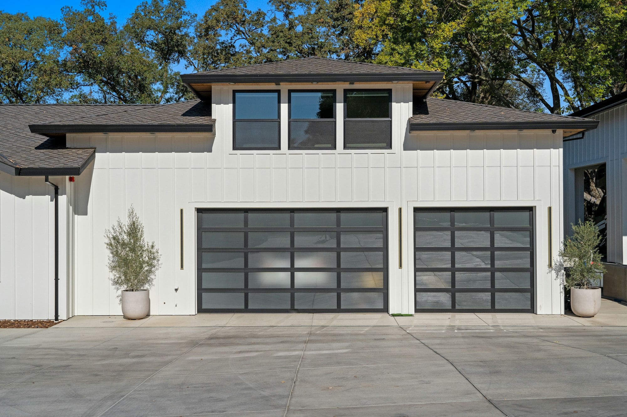 White house with two glass-panel garage doors