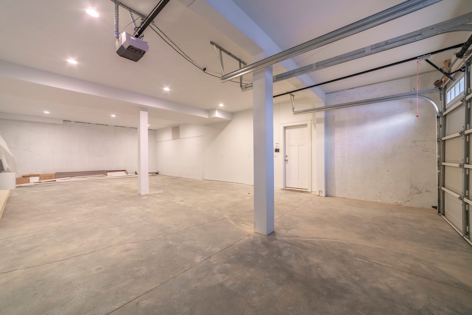 Empty garage with a ceiling-mounted automatic door opener motor